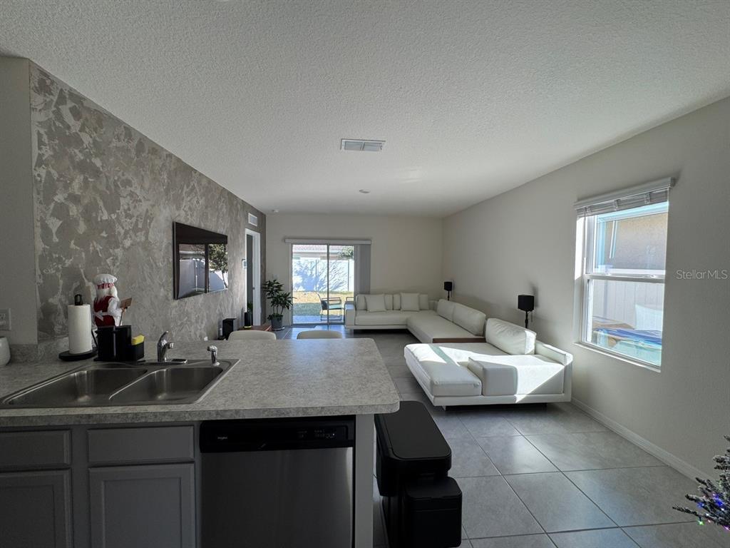 2843 Turnstone Run Harmony, FL 34773 - Photo 29 of 39 a kitchen with a sink and a refrigerator