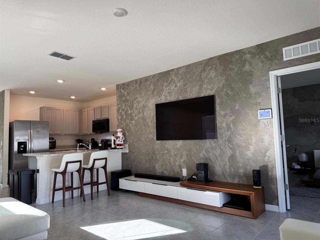 2843 Turnstone Run Harmony, FL 34773 - Photo 32 of 39 a living room with furniture and a flat screen tv