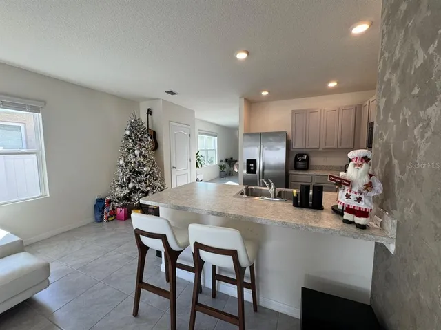 a kitchen with granite countertop and white cabinets