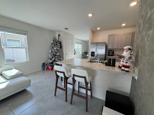 a kitchen with furniture and a potted plant