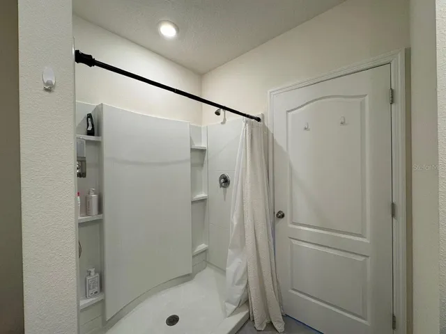 a bathroom with a shower and a toilet
