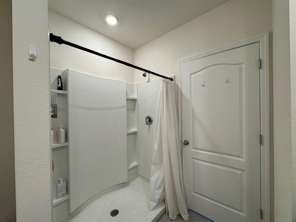 2843 Turnstone Run Harmony, FL 34773 - Photo 5 of 39 a bathroom with a shower and a toilet