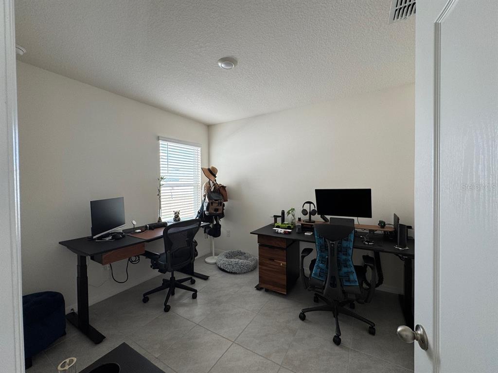 2843 Turnstone Run Harmony, FL 34773 - Photo 9 of 39 a view of a workspace with furniture and a window