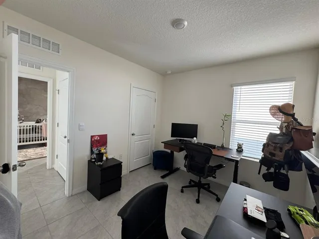 a livingroom with workspace and a couch