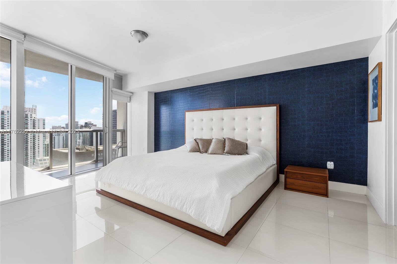 495 Brickell Avenue, Unit 4907 Miami, FL 33131 - Photo 22 of 65 a bed sitting in a spacious bedroom next to a window