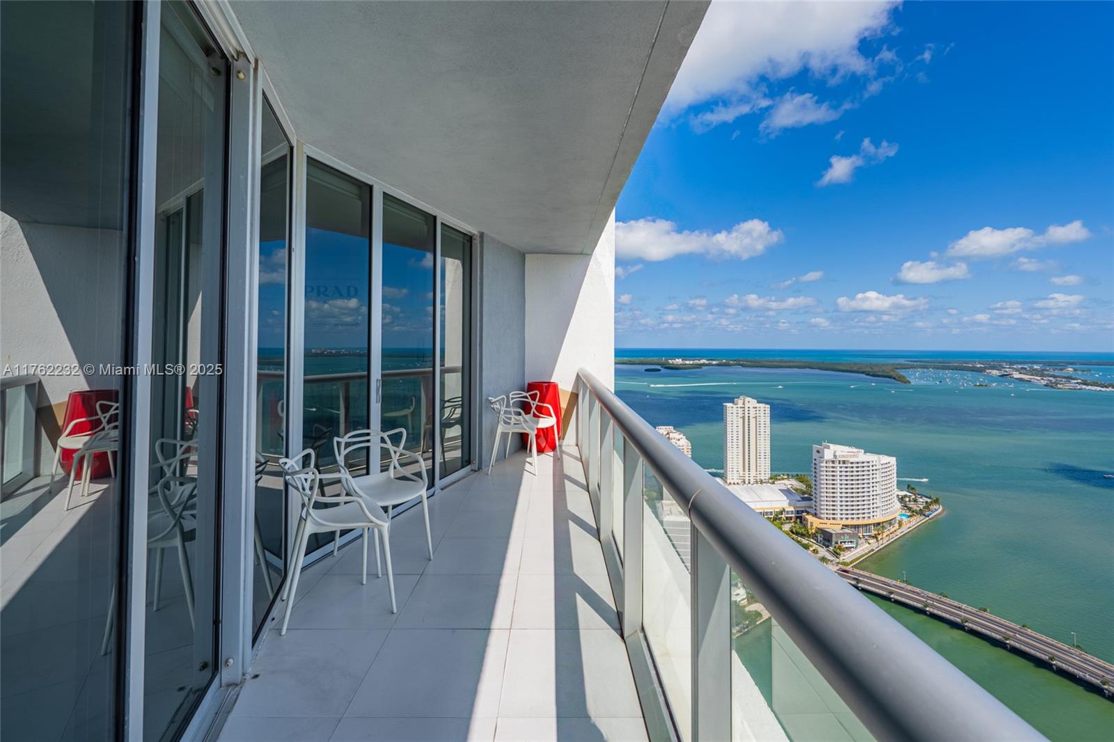 495 Brickell Avenue, Unit 4907 Miami, FL 33131 - Photo 31 of 65 a balcony with wooden floor and outdoor seating