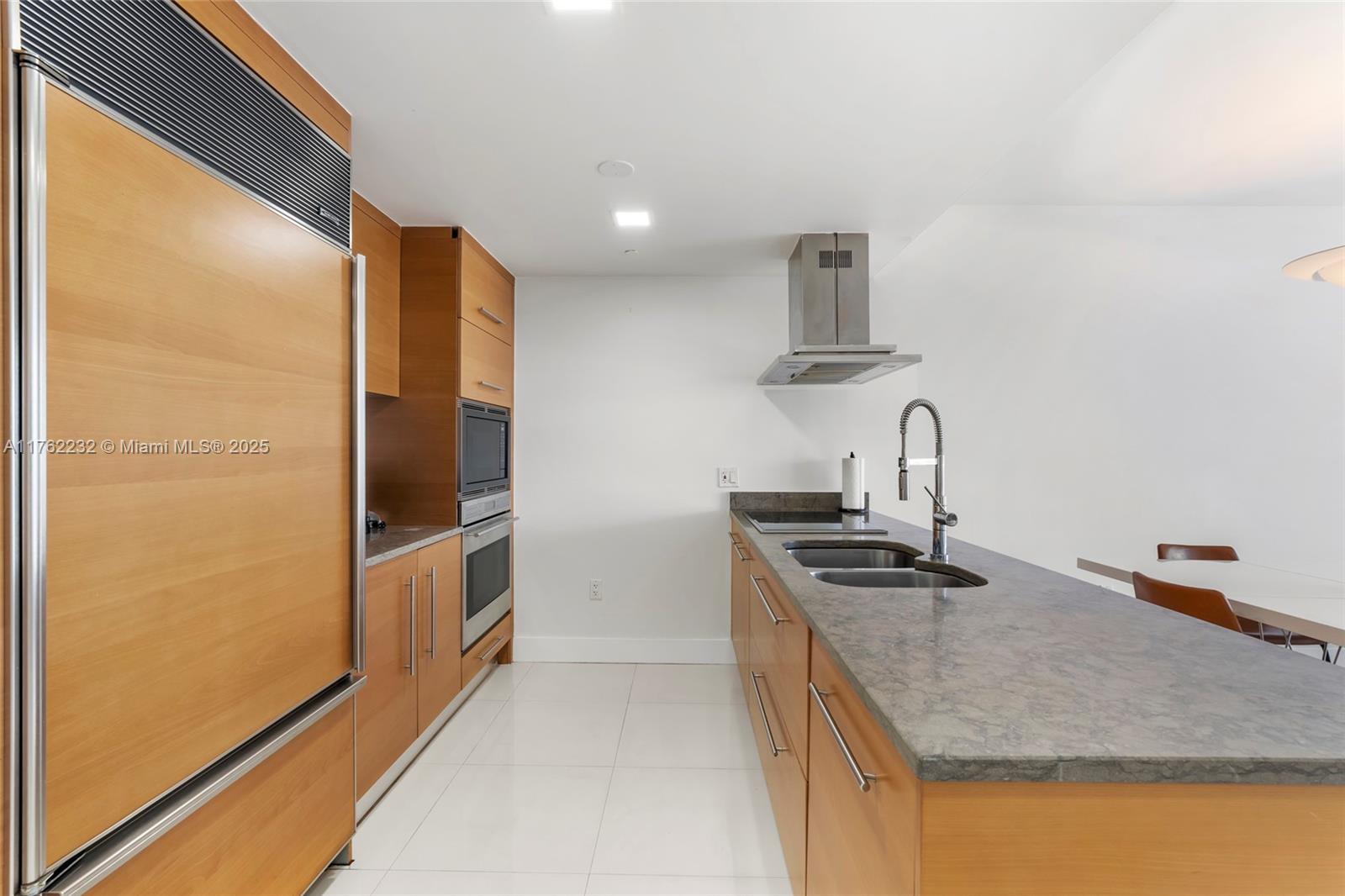 495 Brickell Avenue, Unit 4907 Miami, FL 33131 - Photo 6 of 65 a kitchen with stainless steel appliances granite countertop a sink and a refrigerator