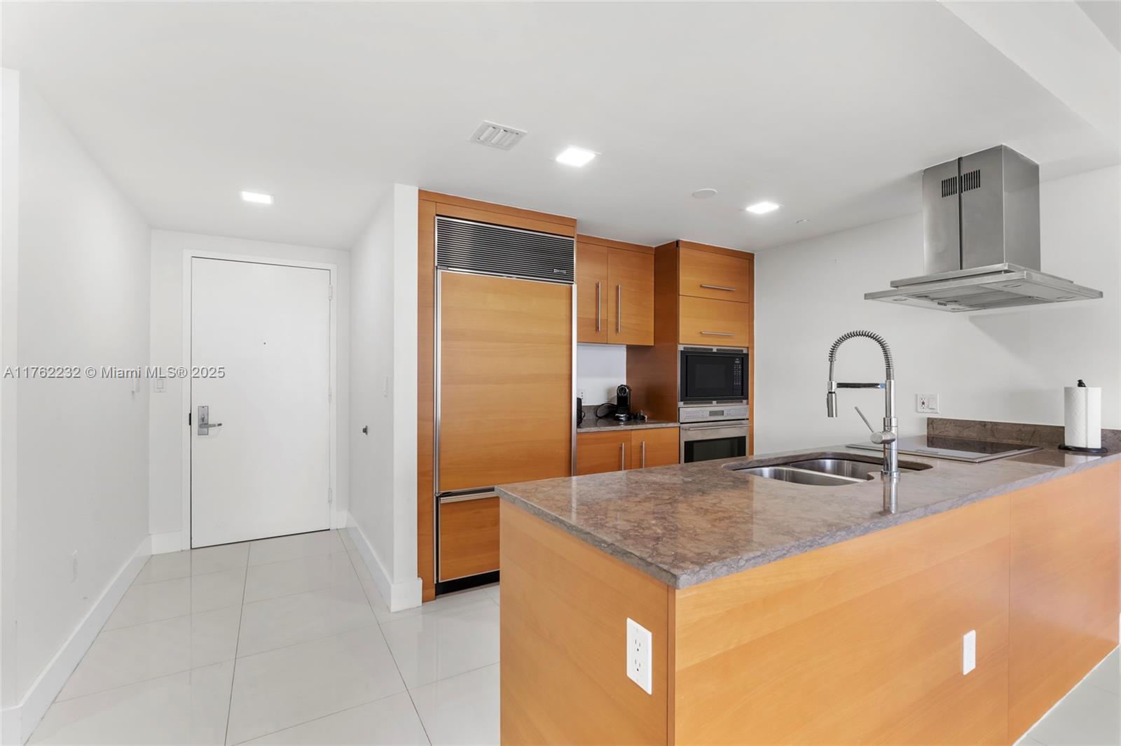 495 Brickell Avenue, Unit 4907 Miami, FL 33131 - Photo 7 of 65 a kitchen with stainless steel appliances granite countertop a sink and a refrigerator