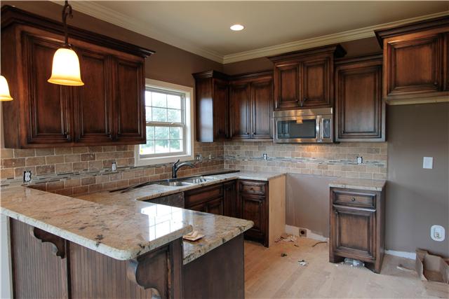 776 Academy Road, Unit 6C Lebanon, TN 37087 - Photo 5 of 16 a kitchen with granite countertop cabinets stainless steel appliances a sink and a window