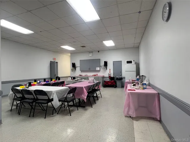 a room with furniture a chandelier pool table and chairs