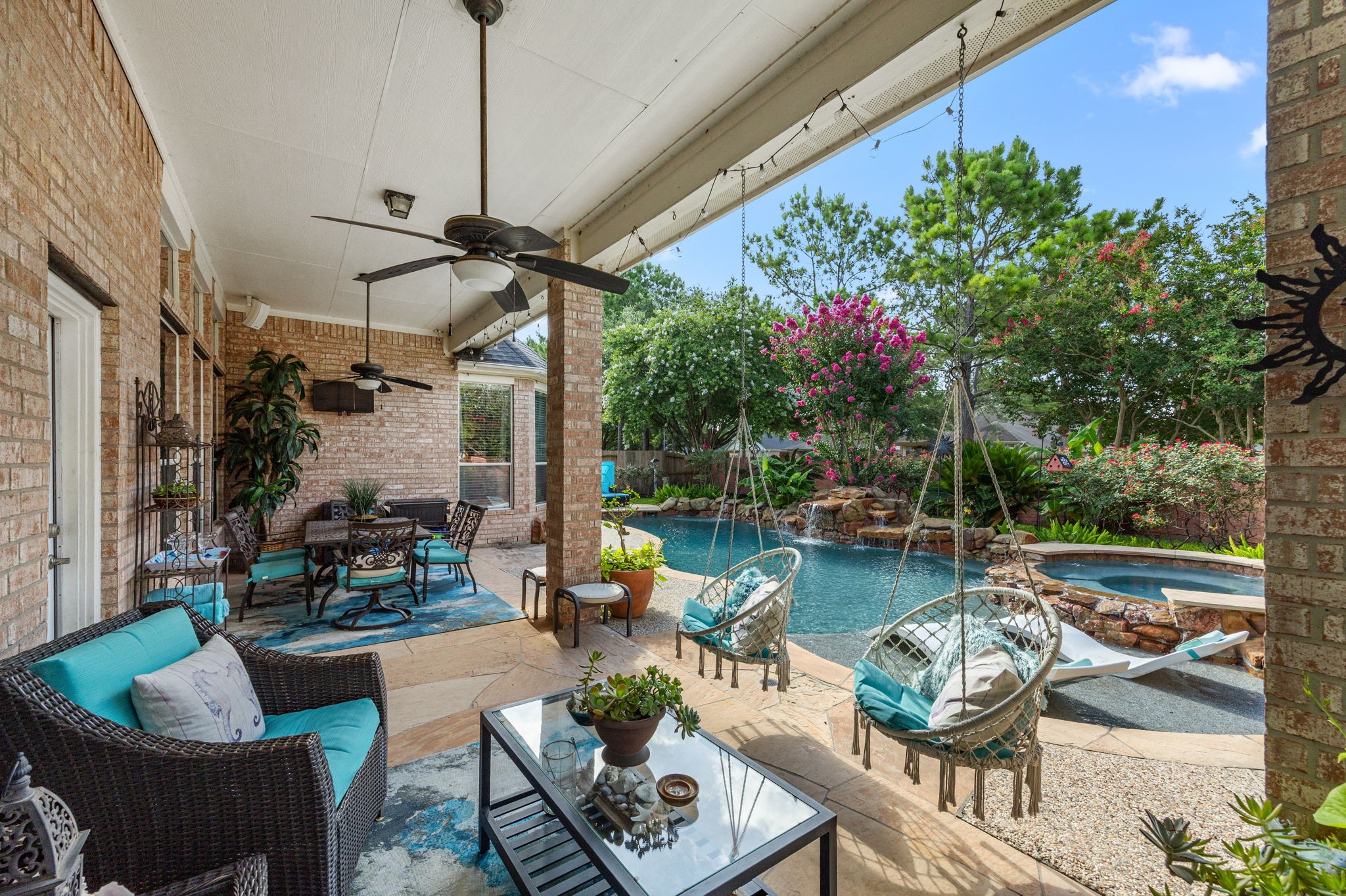 a view of a backyard with swimming pool and furniture