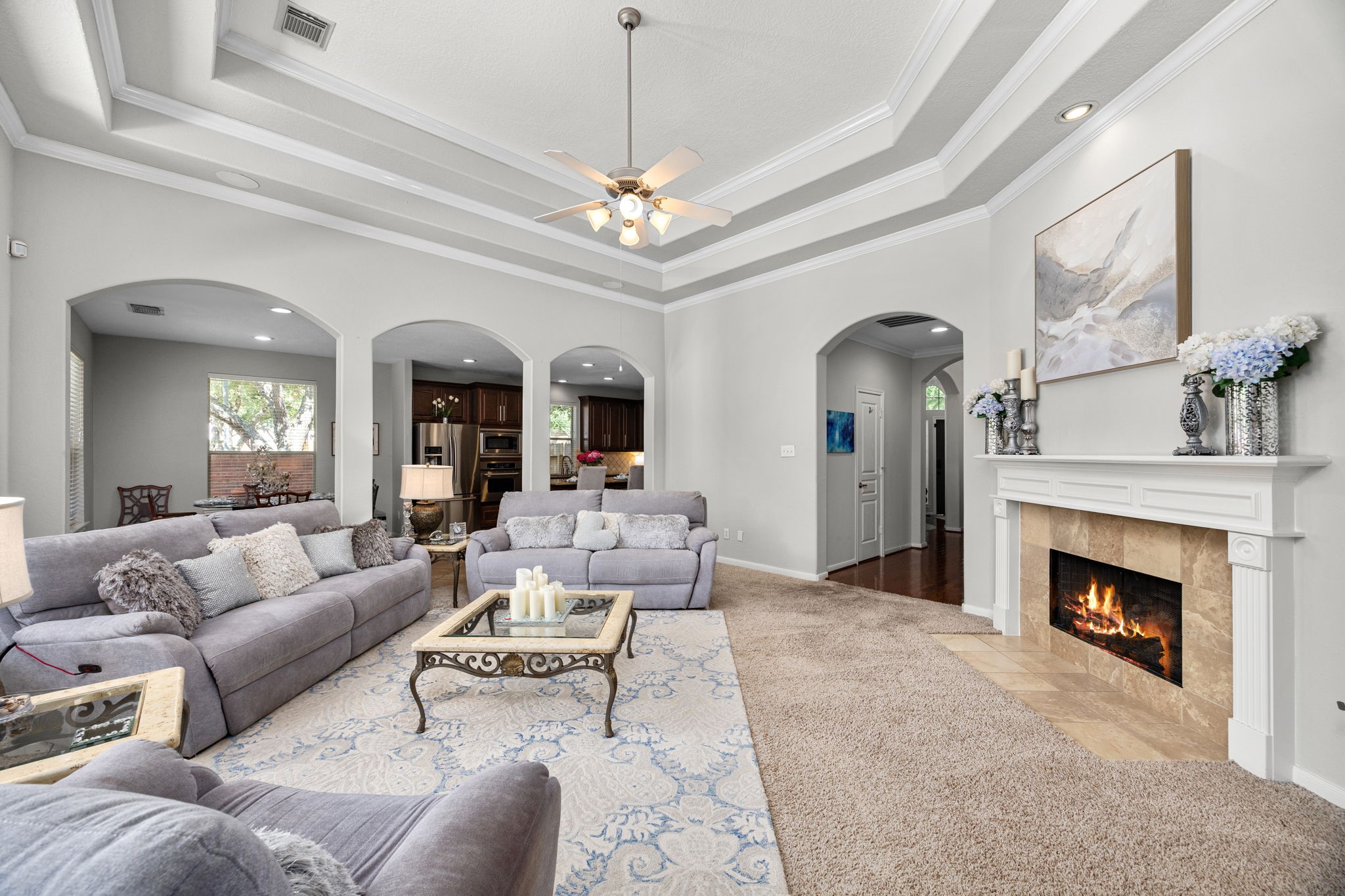 4402 Eden Point Lane Katy, TX 77494 - Photo 2 of 43 a living room with furniture a fireplace and a chandelier