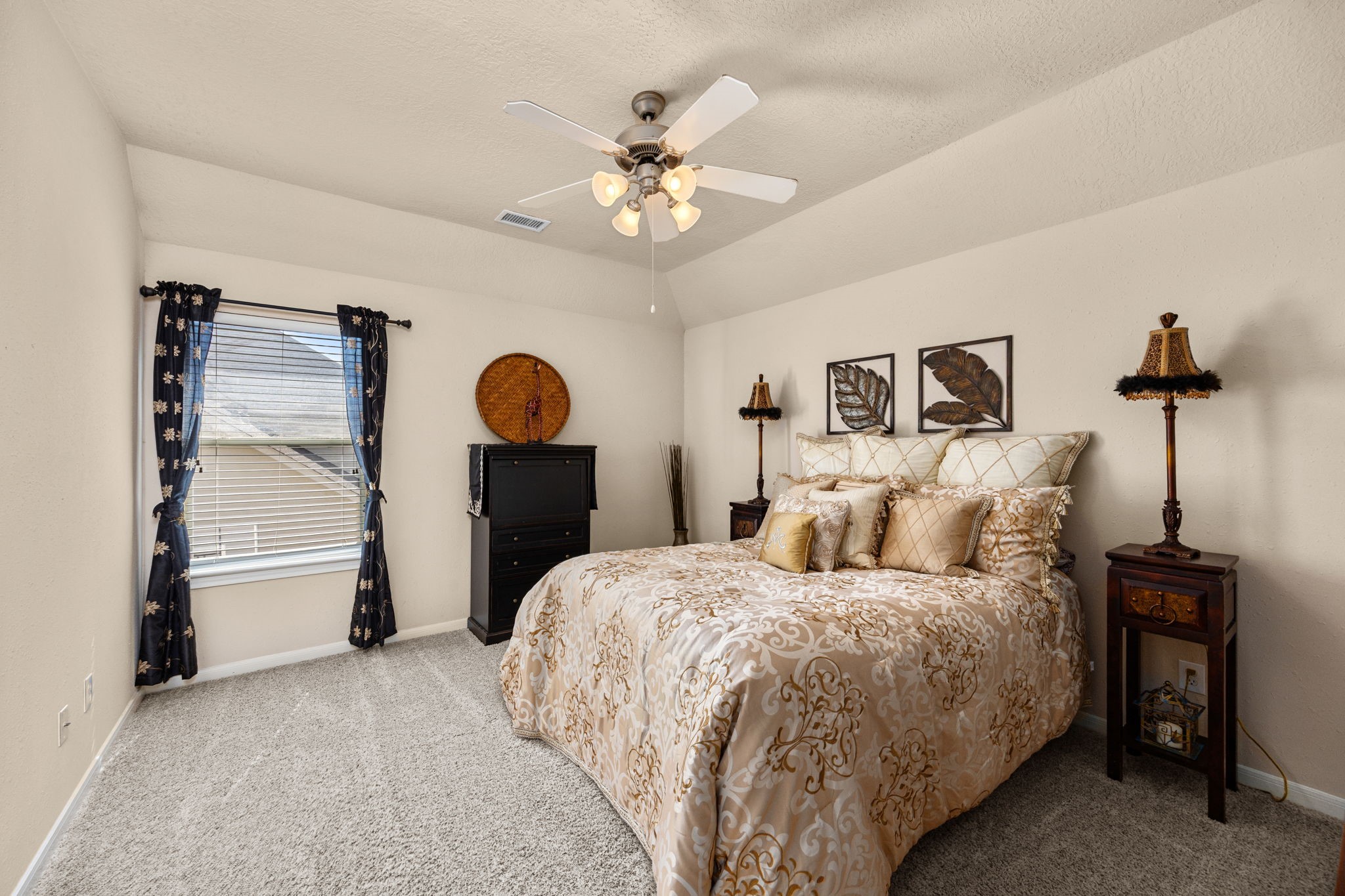 4402 Eden Point Lane Katy, TX 77494 - Photo 24 of 43 a bedroom with a bed and a chandelier