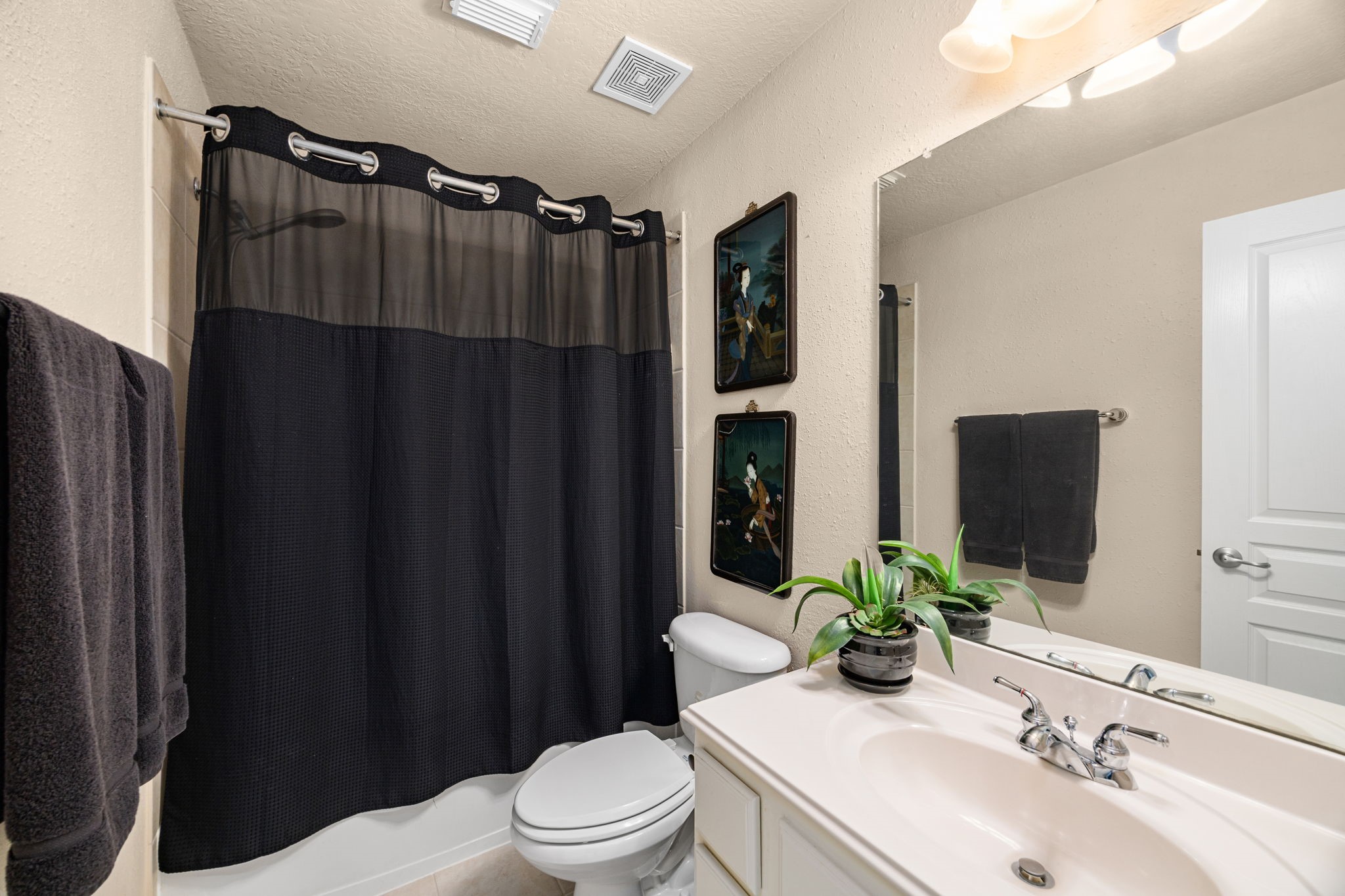 4402 Eden Point Lane Katy, TX 77494 - Photo 25 of 43 a bathroom with a sink a toilet a mirror and shower curtain