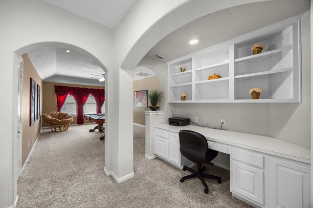 a view of a workspace with a window and shelf