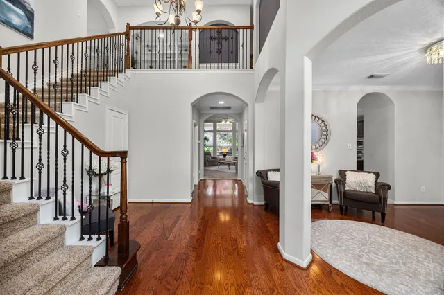 a view of a livingroom with wooden floor and furniture
