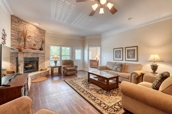 a living room with furniture a flat screen tv and a fireplace