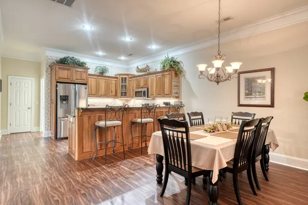 a kitchen with stainless steel appliances granite countertop a refrigerator and a stove top oven