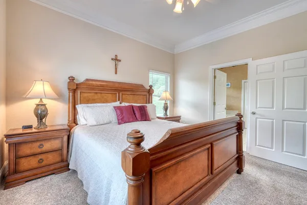 a bedroom with a bed and a television