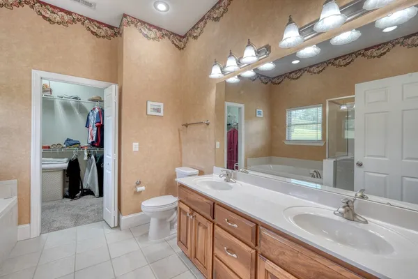 a bathroom with a tub a sink and a shower