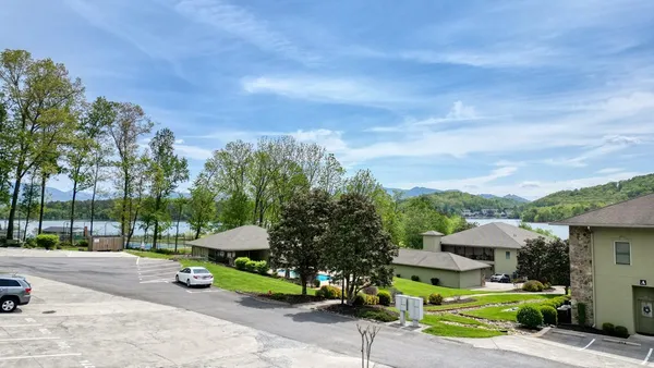 a view of a house with pool and chairs