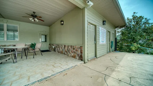 a kitchen with stainless steel appliances granite countertop a refrigerator a stove and a sink with granite countertops