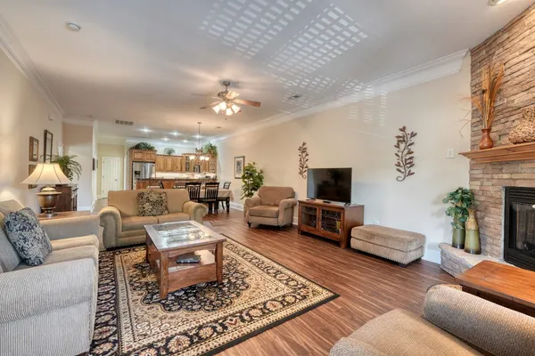 a living room with furniture and wooden floor