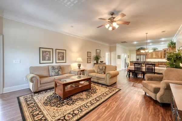 a living room with furniture fireplace and a large window