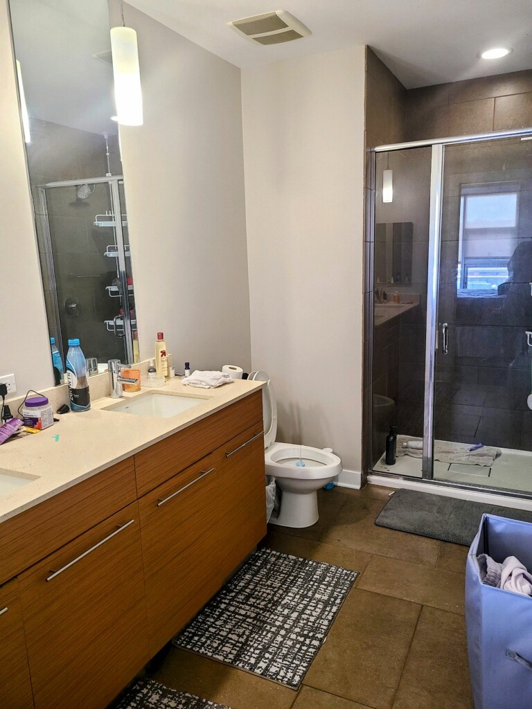 1222 West Madison Street, Unit 501 Chicago, IL 60607 - Photo 5 of 24 a bathroom with a sink toilet and shower