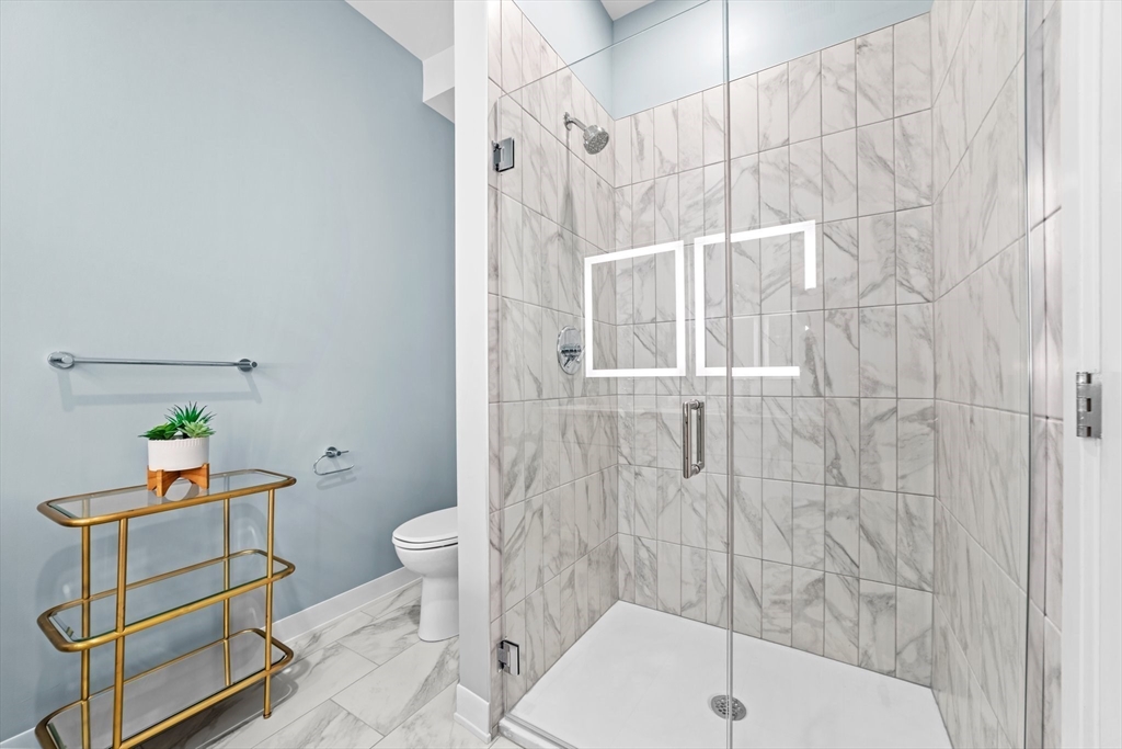 500 Talbot Avenue, Unit 308 Boston, MA 02124 - Photo 11 of 22 a bathroom with a sink toilet and shower