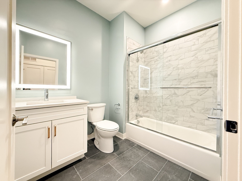 500 Talbot Avenue, Unit 308 Boston, MA 02124 - Photo 12 of 22 a bathroom with a sink toilet a mirror and shower