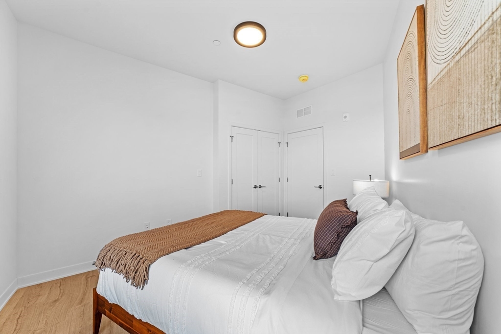 500 Talbot Avenue, Unit 308 Boston, MA 02124 - Photo 14 of 22 a bedroom with a bed and a window