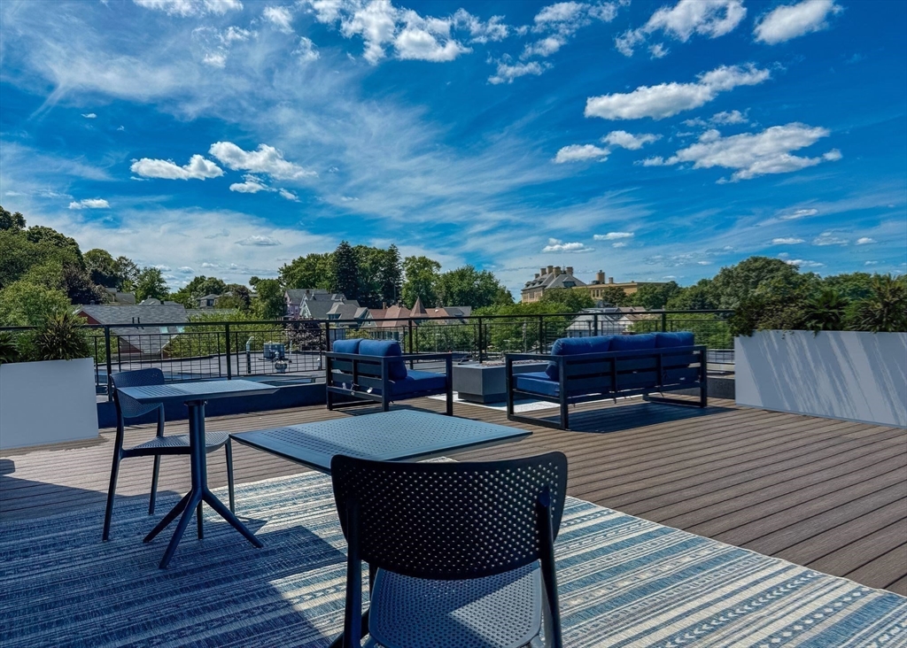 500 Talbot Avenue, Unit 308 Boston, MA 02124 - Photo 18 of 22 a view of a rooftop deck with couch and chairs