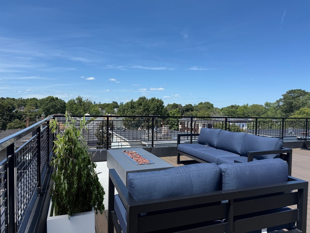 500 Talbot Avenue, Unit 308 Boston, MA 02124 - Photo 20 of 22 a view of a roof deck with couches and wooden floor