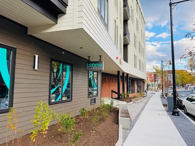 a view of building along with the road and shops