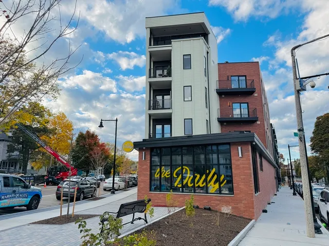 a kitchen with stainless steel appliances granite countertop white cabinets and a stove