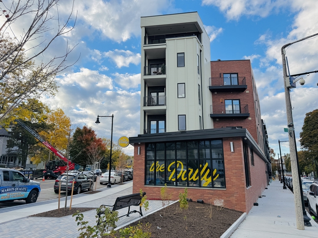 500 Talbot Avenue, Unit 308 Boston, MA 02124 - Photo 3 of 22 a view of building along with the road and shops