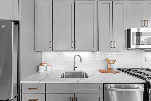 a kitchen with stainless steel appliances a refrigerator stove microwave and cabinets