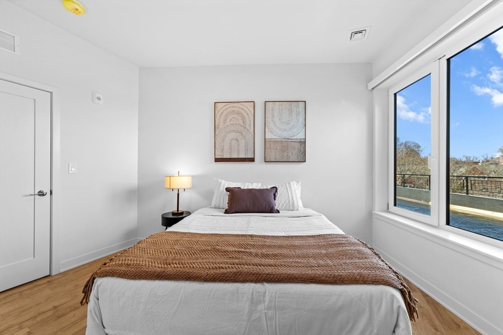 500 Talbot Avenue, Unit 308 Boston, MA 02124 - Photo 8 of 22 a bedroom with a large bed and a window