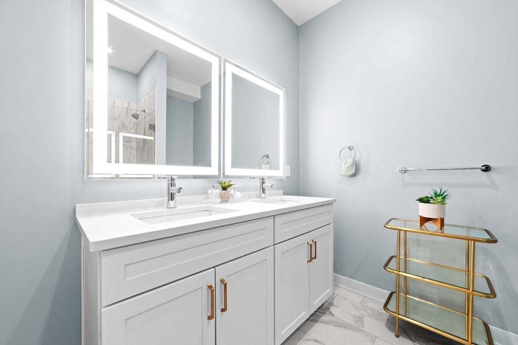 500 Talbot Avenue, Unit 308 Boston, MA 02124 - Photo 9 of 22 a bathroom with a sink and a mirror