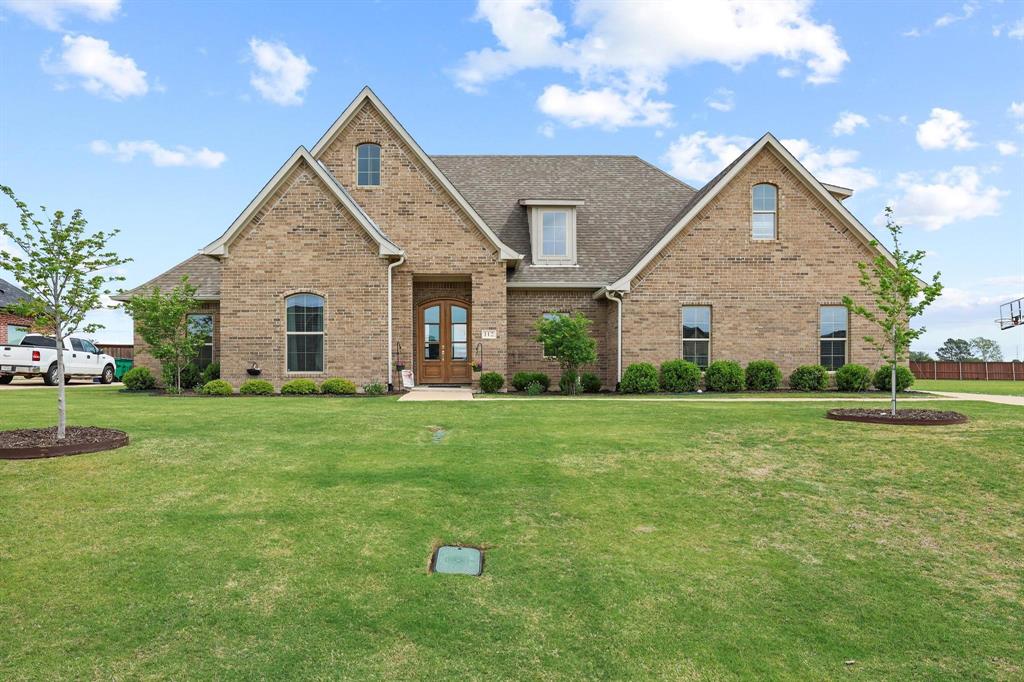 112 Chisolm Trail Pottsboro, TX 75076 - Photo 1 of 40 a front view of house with yard and green space