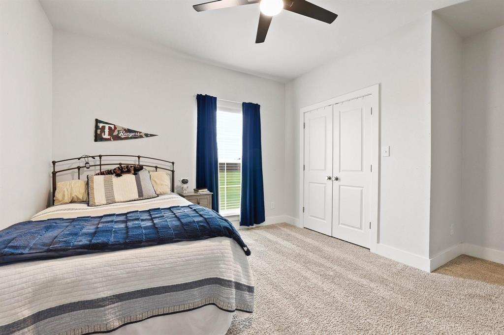112 Chisolm Trail Pottsboro, TX 75076 - Photo 18 of 40 a bedroom with a bed and a ceiling fan