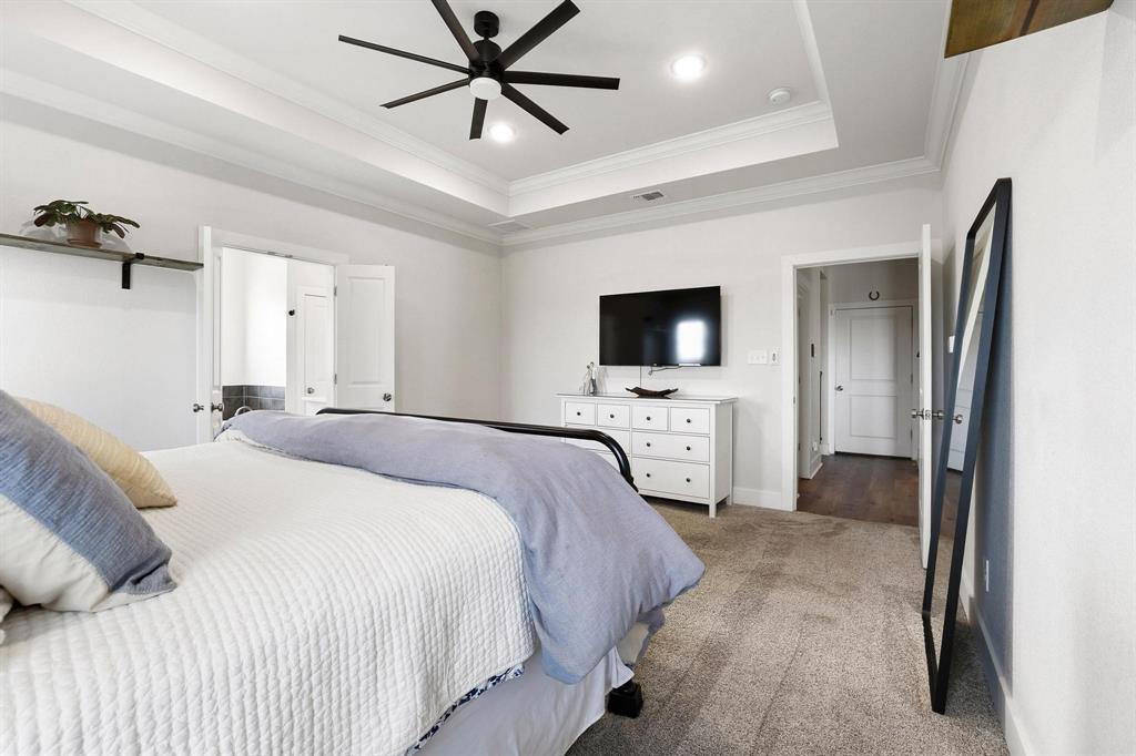 112 Chisolm Trail Pottsboro, TX 75076 - Photo 21 of 40 a bedroom with a bed and a flat screen tv
