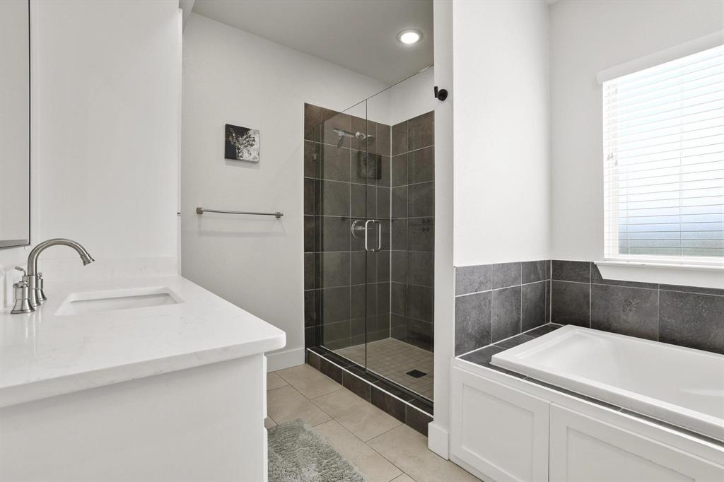 112 Chisolm Trail Pottsboro, TX 75076 - Photo 23 of 40 a bathroom with a sink a toilet and shower