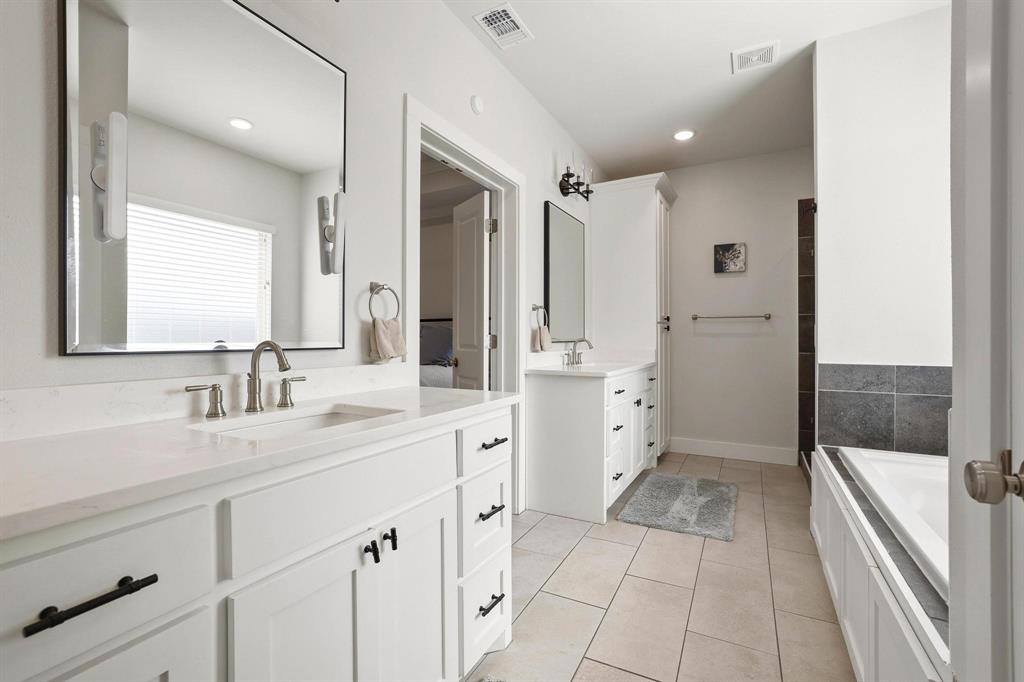 112 Chisolm Trail Pottsboro, TX 75076 - Photo 24 of 40 a spacious bathroom with a shower sink and mirror