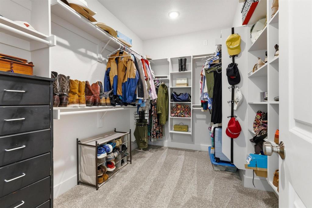 112 Chisolm Trail Pottsboro, TX 75076 - Photo 25 of 40 a view of walk in closet with clothes