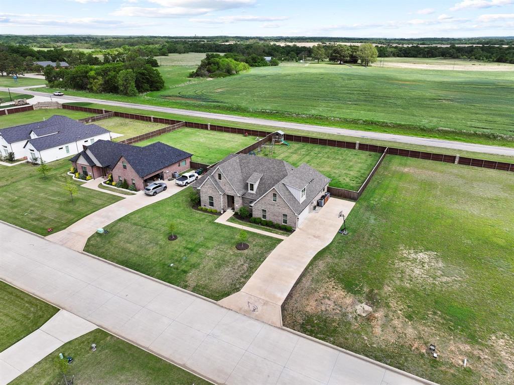 112 Chisolm Trail Pottsboro, TX 75076 - Photo 36 of 40 an aerial view of a house with a garden and lake view