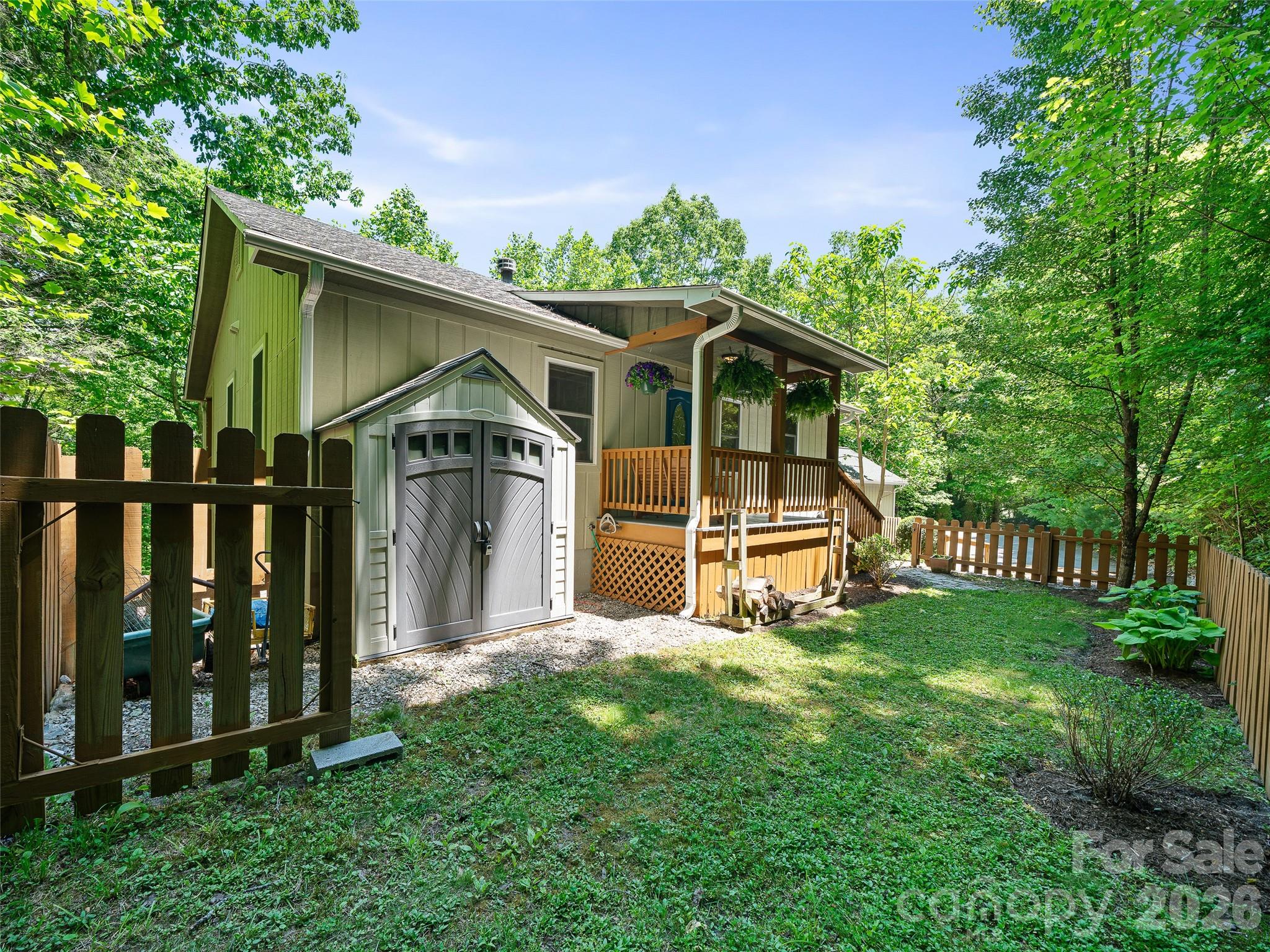 142 Wildflower Road Spruce Pine, NC 28777 - Photo 35 of 46 a view of a house with wooden deck front of house
