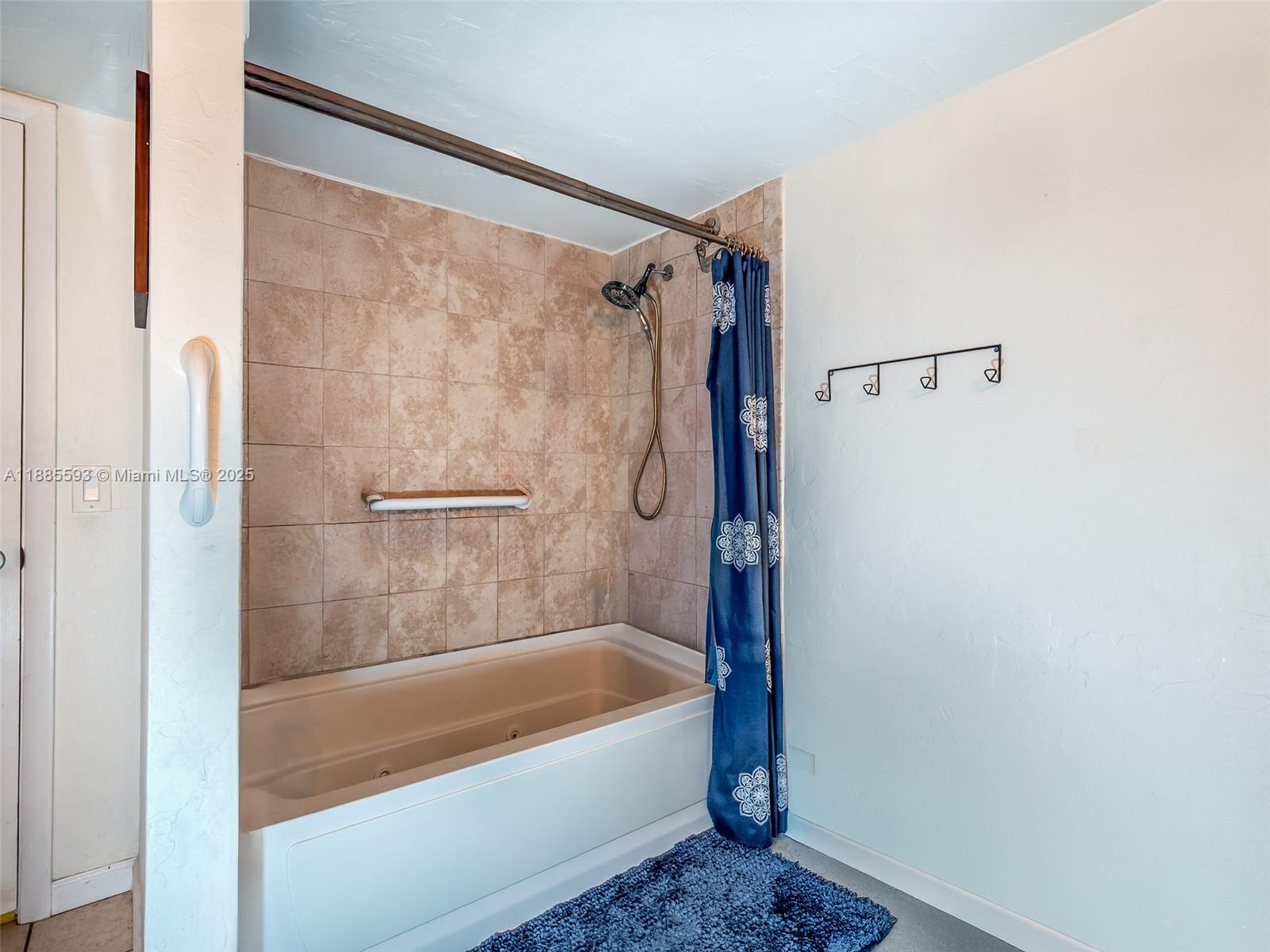 6547 Southwest 116th Place, Unit E Miami, FL 33173 - Photo 14 of 23 a bathroom with a bathtub and a shower