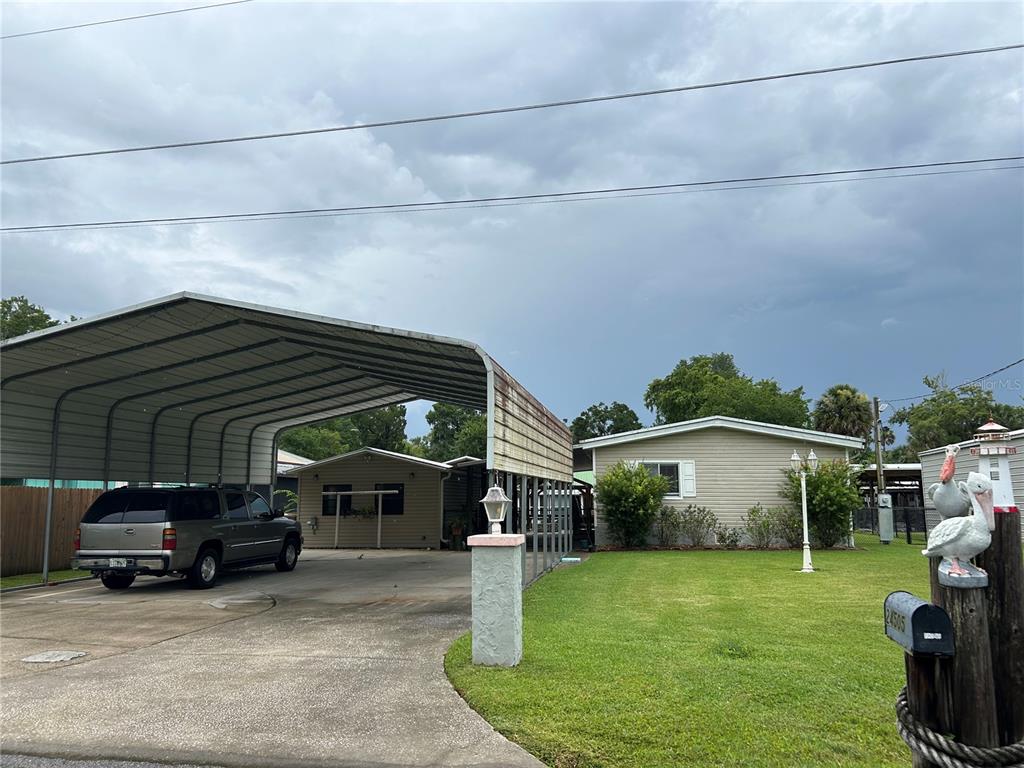 24505 Snail Road Astor, FL 32102 - Photo 1 of 1 a view of a car in front of house